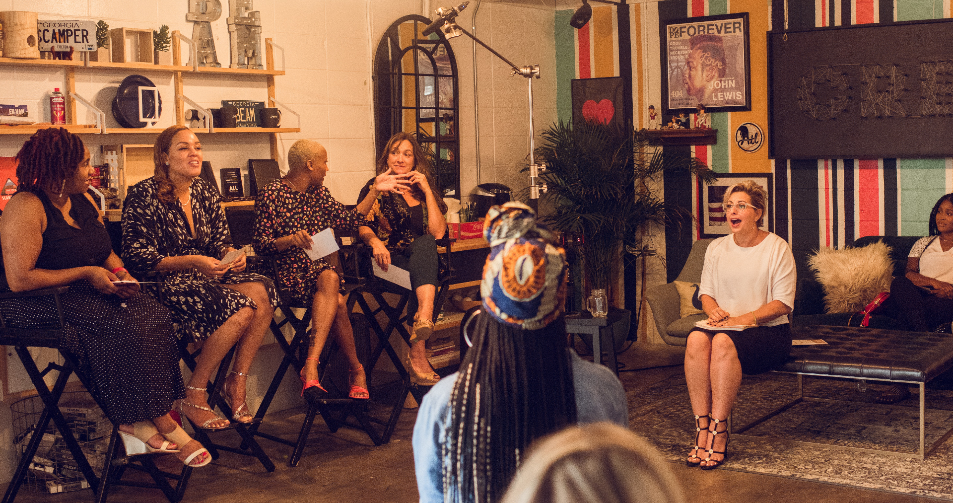 Tamara V. Lucas speaking on a panel with other women